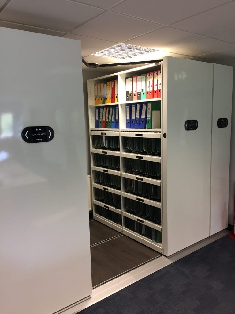 Movable shelves and roller racking in a workspace